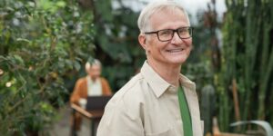 Senior Man With Glasses Smiling After Full Mouth Restoration 