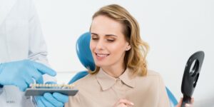 Young Blonde Woman Looking at Dental Implants. 